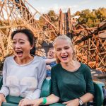 Young friends riding roller coaster ride